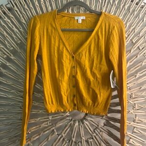 Burnt yellow light cardigan.  Size xxs but can fit up to a xs/s. Button up.  NWT
